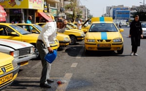 An Iranian taxi driver drenches himself with cold water in Tehran. Some cities in southern Iran hit temperatures above 40C. 