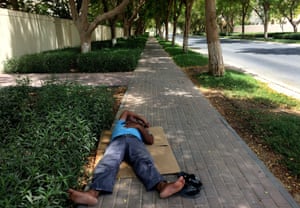 A labourer takes a nap on a street during his break in Dubai, United Arab Emirates. Emirates and other Gulf states began enforcing a work ban during the hottest hours of the day to ensure the safety of outdoor workers, many of whom had suffered from exhaustion before the ban was enforced years ago. 
