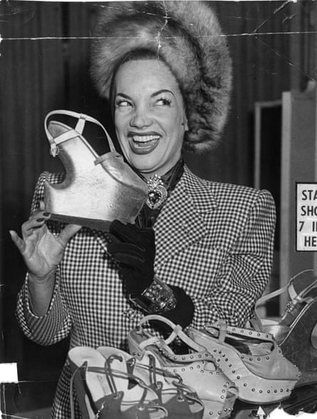 Carmen Miranda holds one of her newly designed evening shoes, which has a 7-inch heel.
