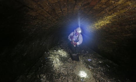 A Thames Water supervisor breaks up a fatberg in the intersection of London’s Regent Street and Victoria sewers.
