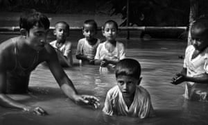 Trained S4D swimming instructors teach a survival swimming lesson to children at a village in Narsingdi, Bangladesh. Every year, around 17,000 children die from drowning in this flood-prone country.