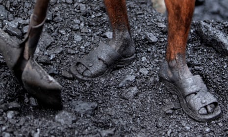 An Indian labourer works at a coal depot on the outskirts of Jammu, India.