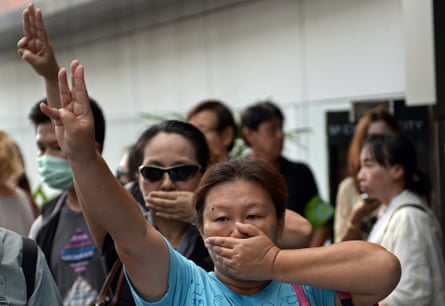 Opponents of Thailand's military coup are risking arrest by flashing the three-finger salute from the "Hunger Games" movies to defy a junta that has banned all public protests.
