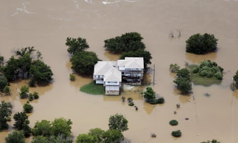 Flood waters from the Brazos River encroach upon a home in the Horseshoe Bend neighborhood, Friday, May 29, 2015, in Weatherford, Texas.