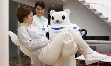 A Robear nursing robot carries a patient during a test exercise in Japan