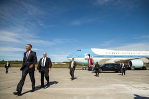 President Barack Obama walks to greet visitors after arriving at Elmendorf air force base
