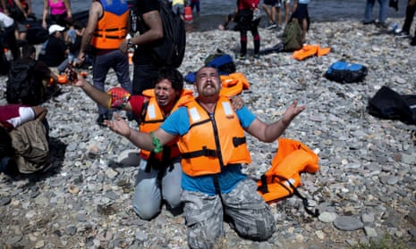 Refugees from Syria pray after arriving on the shores of the Greek island of Lesbos aboard an inflatable dinghy across the Aegean Sea from Turkey. Photograph: Angelos Tzortzinis/AFP/Getty Images