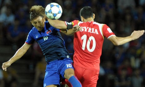 Kouch Sokumpheak of Cambodia (L) fights for the ball with Abdulrazak Al Husein of Syria (R) during the 2018 World Cup qualifying football match between Cambodia and Syria in Phnom Penh on September 8, 2015. 