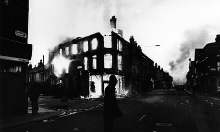 A policeman stands guard after another night of rioting in Toxteth.