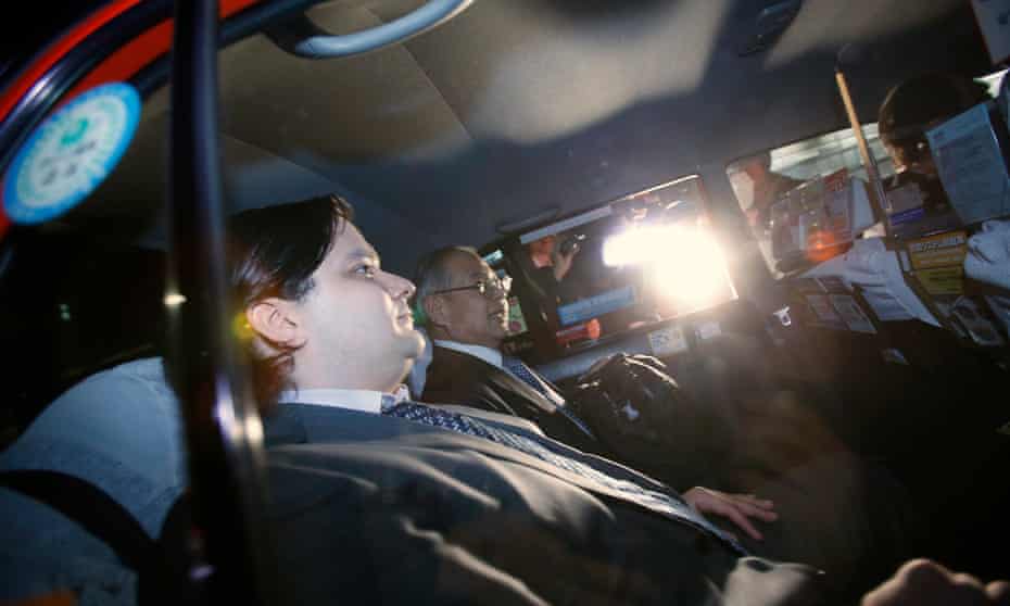 Mark Karpeles (L), chief executive of Mt. Gox, leaves in a taxi after a news conference at the Tokyo District Court in Tokyo February 28, 2014.