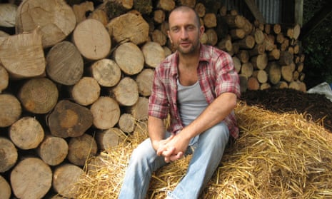 Mark Boyle (moneyless man) sitting on hay bale