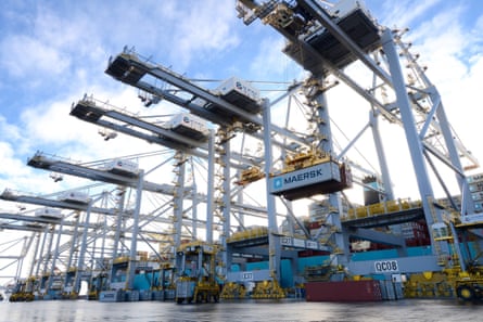 Enormous tandem-lift cranes load and unload containers.