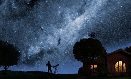 A man gazes at the Milky Way outside his house