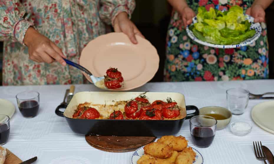 stuffed tomatoes and croquetas being served at a table
