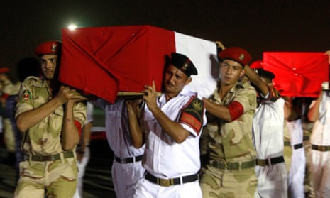 The caskets of policemen killed near the north Sinai town of Rafah are carried after a series of attacks in August 2013.