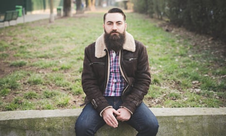 A hipster with a beard in a park