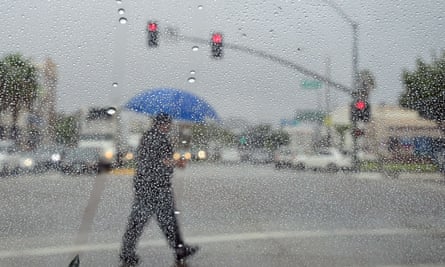 Man crossing rainy street in LA