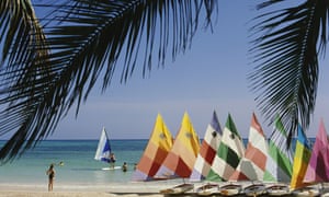A row of colourful sailing boats lined up on Trelawny Beach, Jamaica