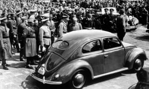 Adolf Hitler inspects the new 'people's car' in 1938.