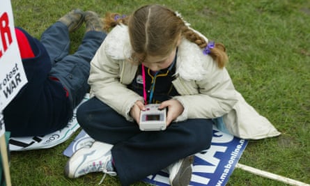 A girl playing a Gameboy during an anti-Iraq War demonstration in London