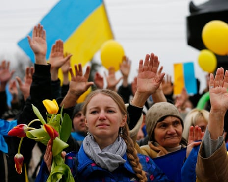 Pro-Ukrainian supporters raise their hands to remember the victims of violence in recent protests in Kiev in March, 2014.
