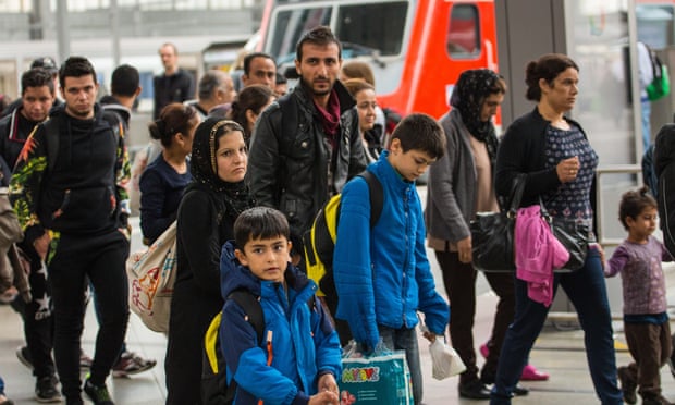 Migrants are brought through the central station in Munich to the registration area