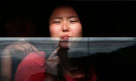 A North Korean defector looks out of a police vehicle while being transported to a Thai court.