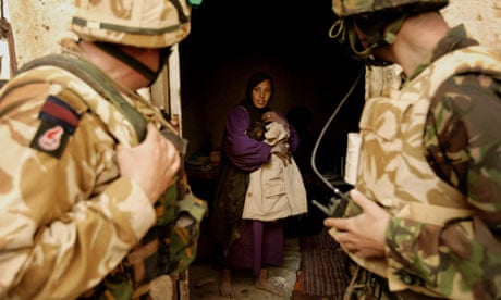 British soldiers visit locals in a village south of Basra in 2003