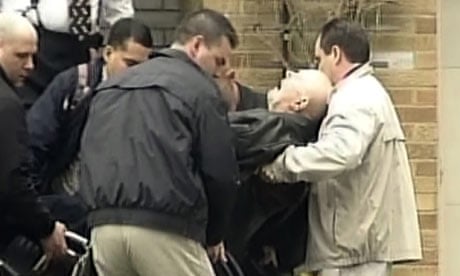 John Demjanjuk being carried out of his home in Ohio in April