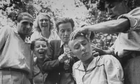 A crowd jeers as a woman’s head is shaved during the liberation of Marseilles