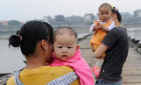 Chinese mothers hold babies in Ganzhou