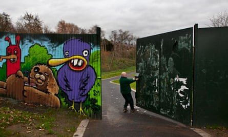 A park employee closing the peace wall in Belfast