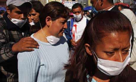 People wear surgical masks as they wait in a line at Mexico City's general hospital