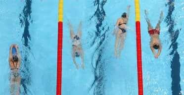 Swimmers practice in a pool