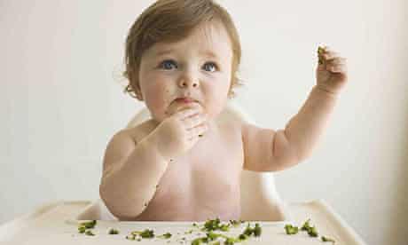 A baby eating solid food