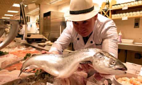 A fishmonger displays a salmon