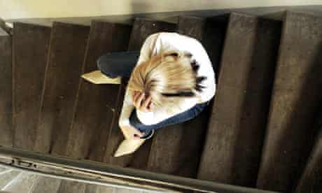 Depressed woman sitting on steps