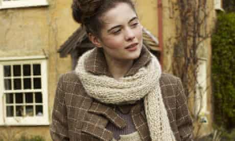 A model wears a jacket and scarf by Izzy Lane