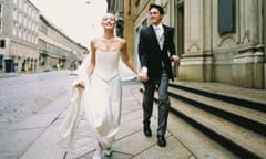 Newlyweds holding hands on on a city street