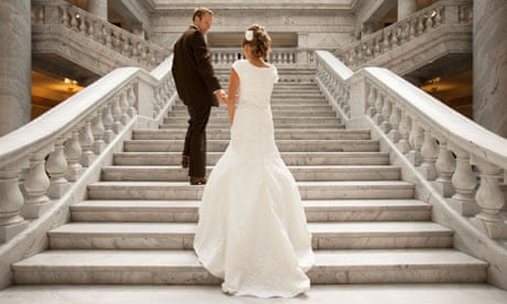Bride and groom holding hands on steps