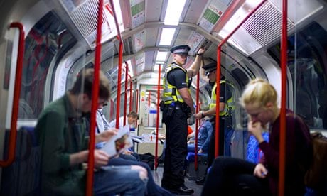 Police officers patrol the London underground