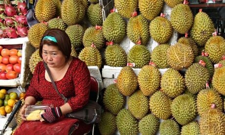A woman selling durians