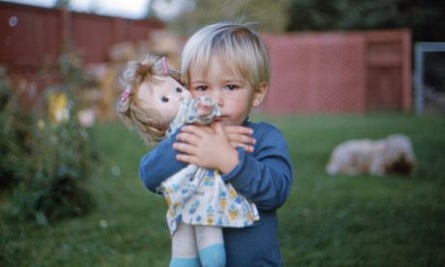 A boy with his sister's doll.