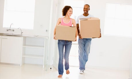 Couple with boxes moving into new home