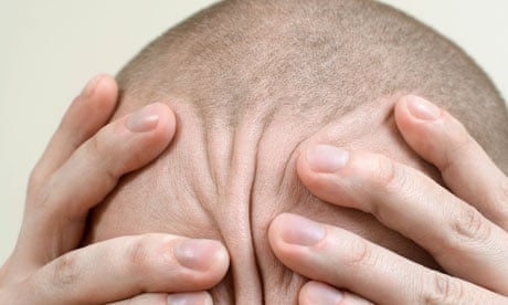 Detail of a man rubbing his head