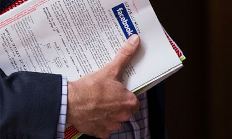A man holds a Facebook pamphlet 