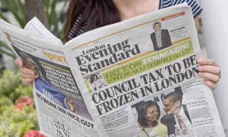 A woman reads the Evening Standard on the day it was announced it would go free
