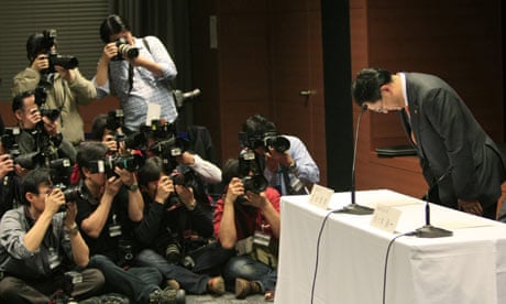 Toyota Motor Corp President Akio Toyoda bows at the start of a news conference in Nagoya