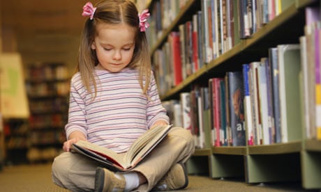 Young girl reading in library