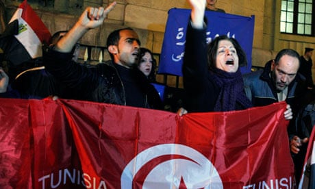 Egyptian activists with a Tunisian flag as part of anti-government demonstrations